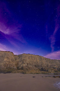 Scenic view of rock formation against sky at night