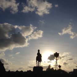 Low angle view of silhouette statue against sky during sunset