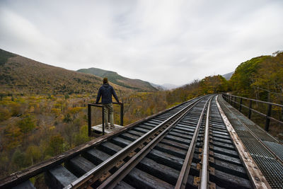 Abandoned railroad trestle high above new england autumn forest