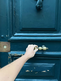 Hand holding the door handle