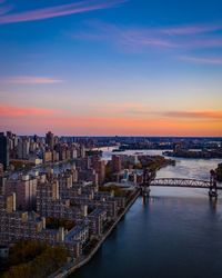 High angle view of buildings against cloudy sky during sunset