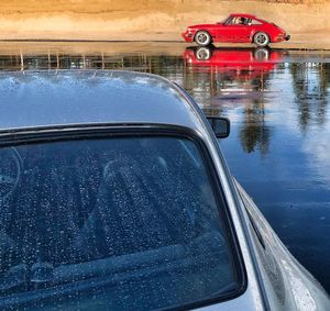 Reflection of car on wet windshield during rainy season