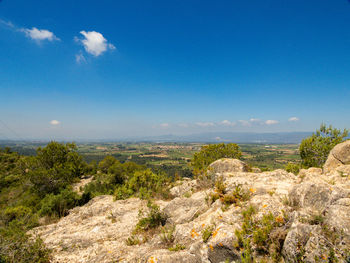 Scenic view of the landscape against blue sky