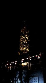 Low angle view of illuminated christmas tree at night