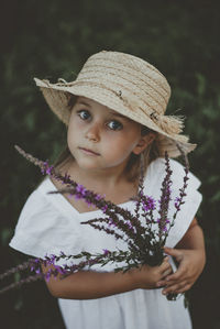 Portrait of girl holding flowers