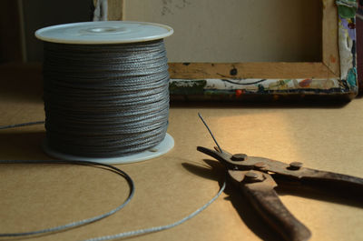 Steel cables and wire cutter on table in workshop