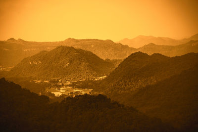 Scenic view of mountains against clear sky during sunset