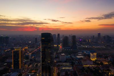 Aerial view of buildings in city against sky during sunset