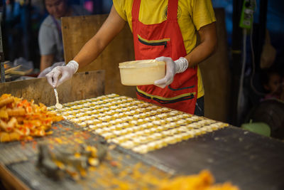 Midsection of woman preparing food