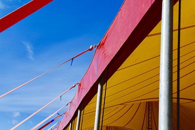 Low angle view of sailboat against blue sky