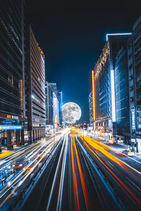 High angle view of light trails on road at night