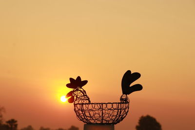 Silhouette of people against orange sky