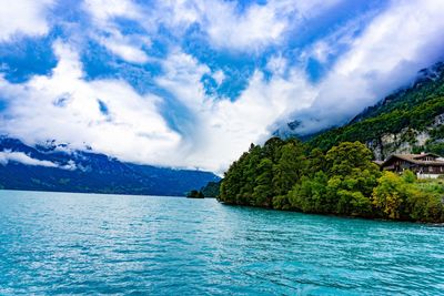 Scenic view of sea and mountains against sky