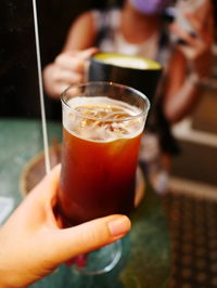 Cropped hand holding drink - coffee break for two - pov 