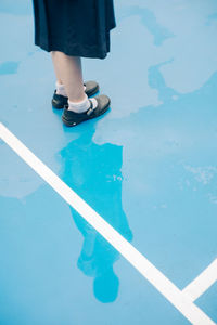 Low section of woman standing on basketball court