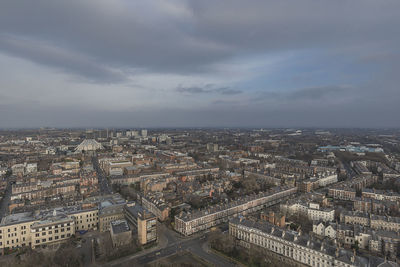 High angle view of cityscape against cloudy sky