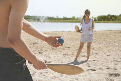 Boy playing with ball on beach