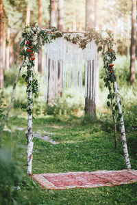 Wedding arch with macrame in the forest, boho style