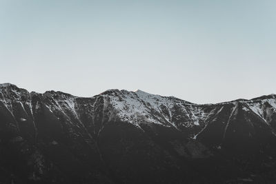 Scenic view of snowcapped mountains against clear sky