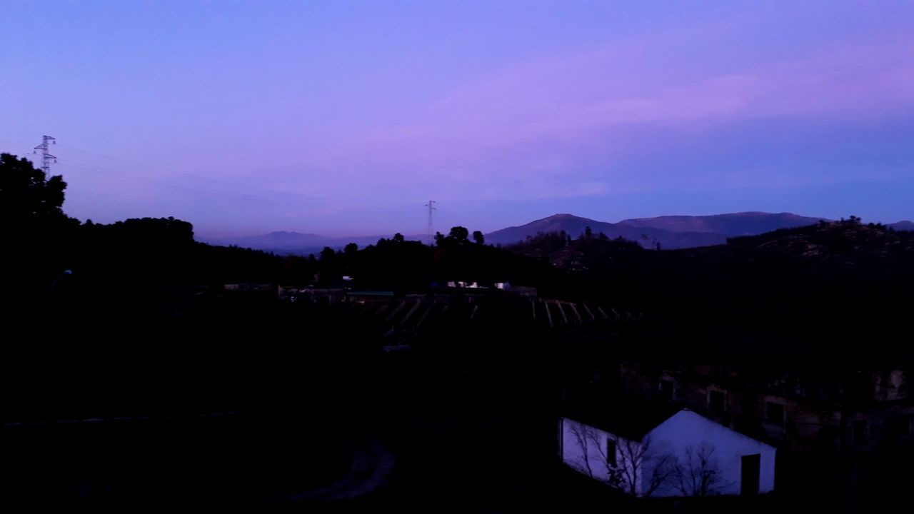 SILHOUETTE TREES AND BUILDINGS AGAINST SKY AT SUNSET