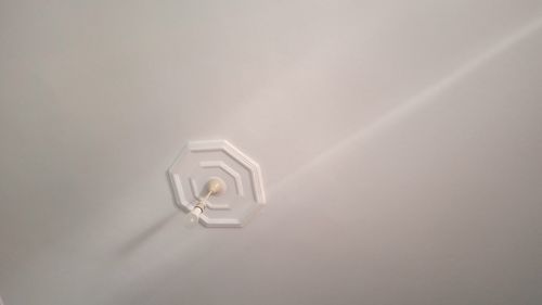 Close-up of light bulb against white background