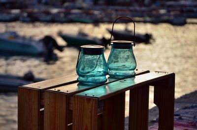 Close-up of glasses on table at beach