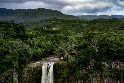 Scenic view of waterfall against sky