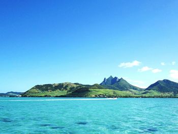 Scenic view of sea and mountains against sky