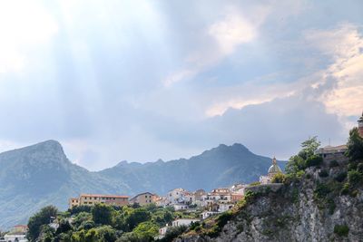 Town by mountains against sky