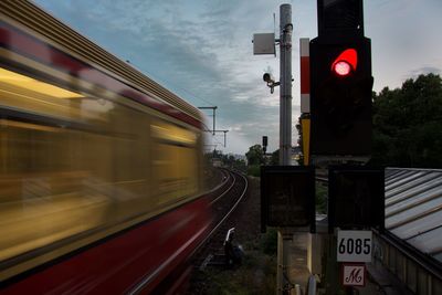 Blurred motion of train against sky during sunset