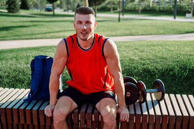 Portrait of young man exercising in park