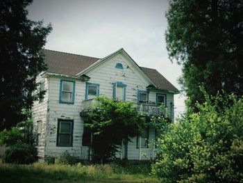 House and trees against sky