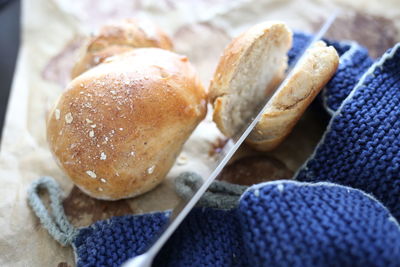 High angle view of bread buns being cut 