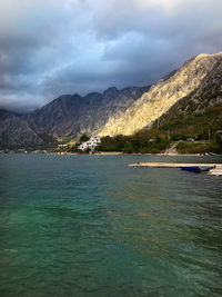 Scenic view of sea and mountains against sky