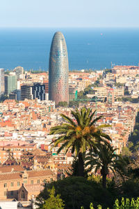 High angle view of buildings and sea against sky