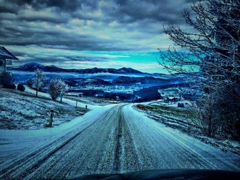 Road passing through snow covered landscape