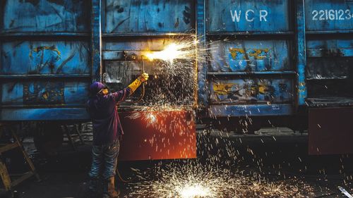 Blurred motion of man working on metal