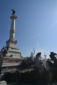 Low angle view of statue against blue sky