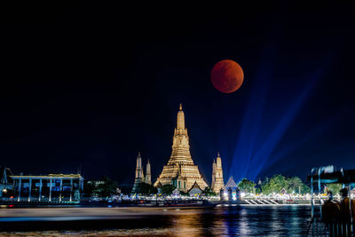 Lunar eclipse, super red full moon taken from top side of  wat arun temple in bangkok thailand.