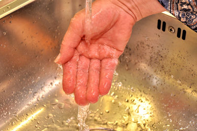 Cropped image of woman washing hands