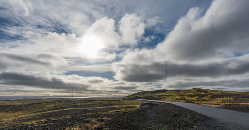 Road amidst landscape against sky