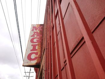 Low angle view of text on building against sky