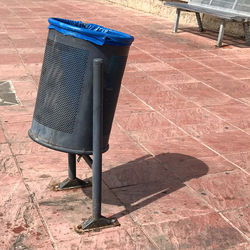 High angle view of empty chair on footpath