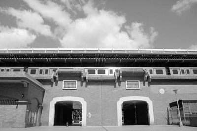 Low angle view of built structure against cloudy sky