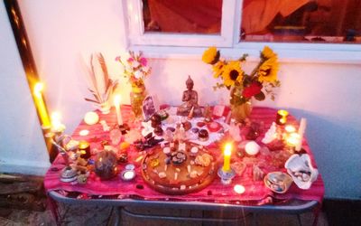 Close-up of lit candles on table at illuminated temple