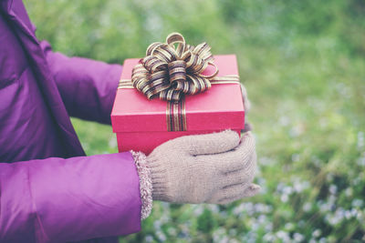 Close-up of hand holding umbrella in box