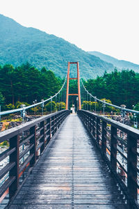 Bridge over footbridge against clear sky