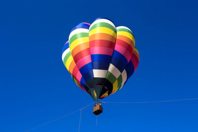 Low angle view of hot air balloon against blue sky