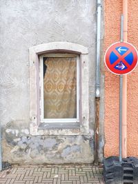 No parking sign on street against building