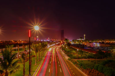 High angle view of light trails on highway at night